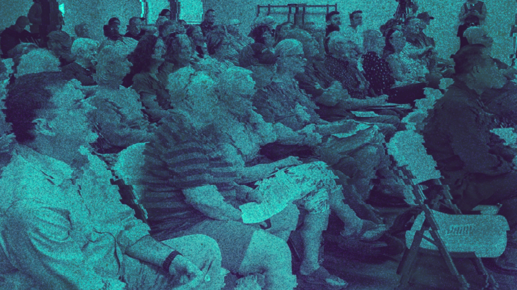 A distorted image of residents attending a data center town hall.